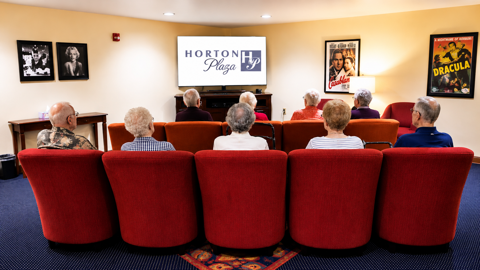 HORTON theater room Residents watching a movie in the cozy theater room at Horton Plaza retirement community